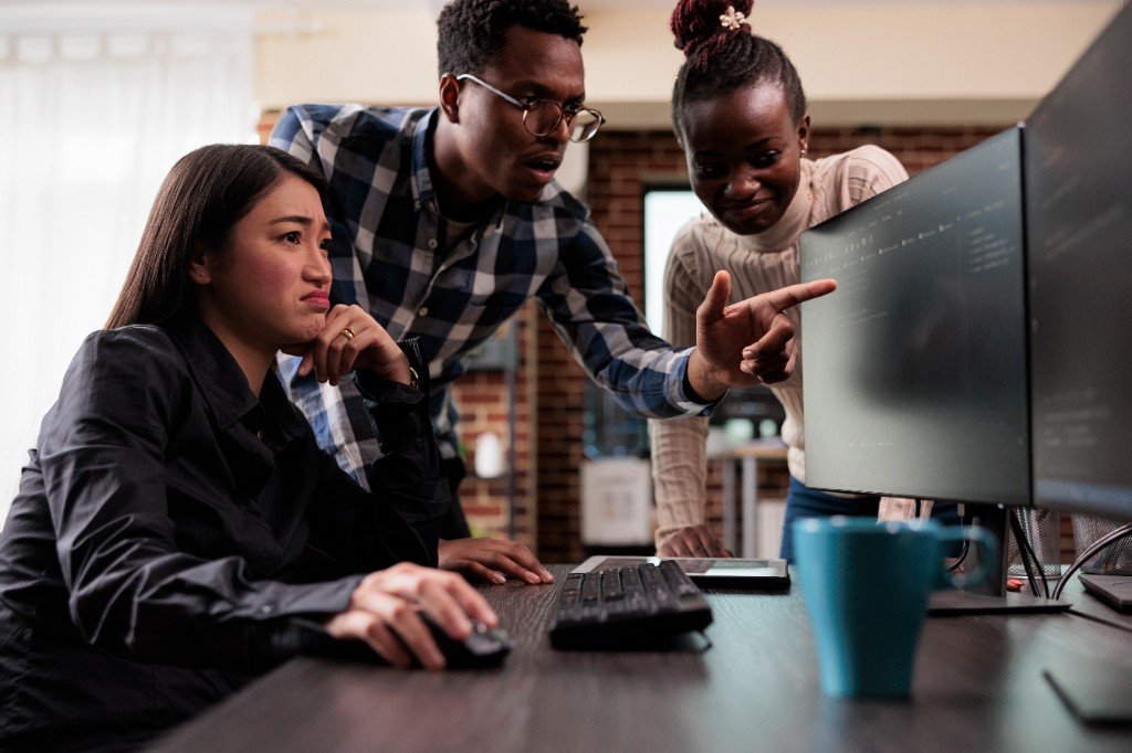 People reviewing code together at a desk
